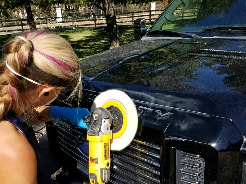DaNae Boyd, owner of ABC Mobile Detail in Granite Bay, CA polishing out scratches on this Ford trucki