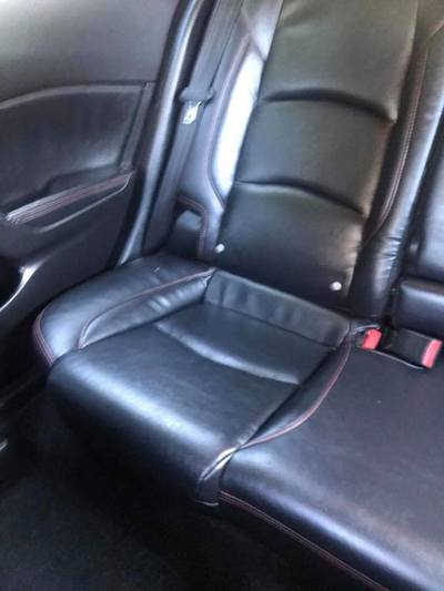 Rear seat on passenger side of skunked Mazda after detail by ABC Mobile Detail Granite Bay, CA